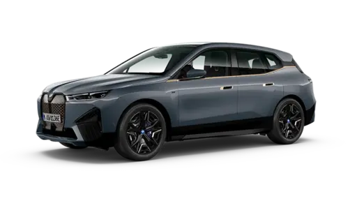 Gray-blue modern electric crossover SUV shown in a front three-quarter view, featuring sleek LED headlights, a sculpted aerodynamic body, black alloy wheels, tinted windows, and a prominent enclosed front grille area. The vehicle is isolated against a transparent or black background.